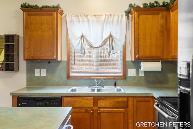 kitchen with light countertops, decorative backsplash, brown cabinetry, a sink, and black appliances