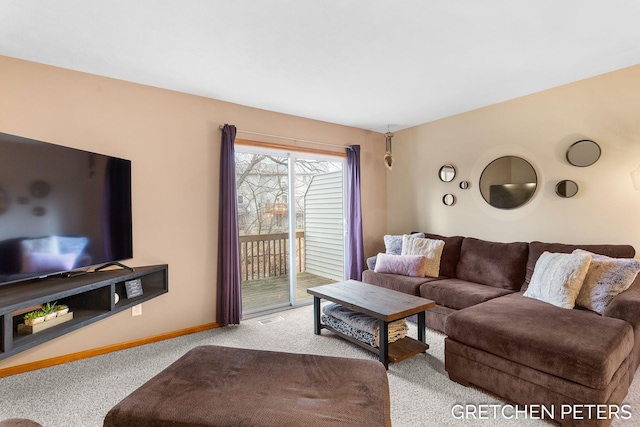 living area featuring carpet floors, visible vents, and baseboards