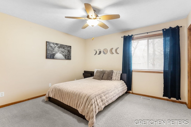 bedroom with a ceiling fan, carpet flooring, visible vents, and baseboards