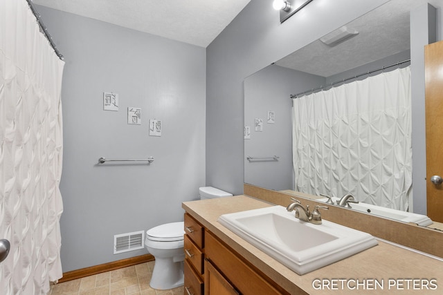 full bath featuring baseboards, visible vents, toilet, a textured ceiling, and vanity