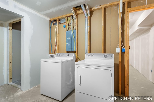 washroom featuring laundry area, washing machine and dryer, and electric panel