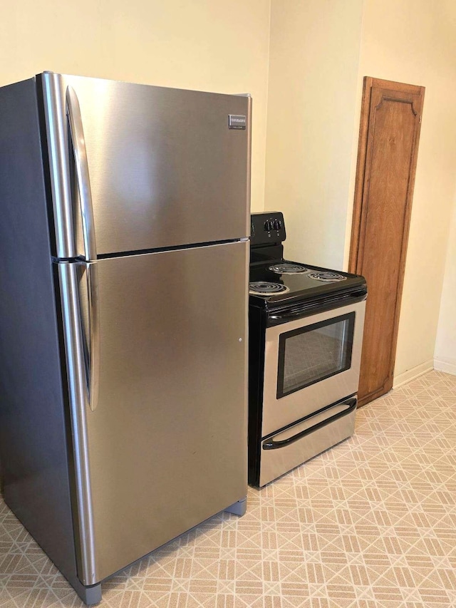 kitchen featuring light floors and appliances with stainless steel finishes