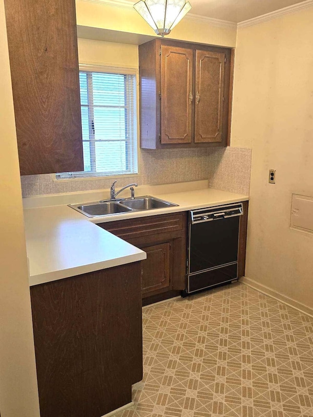 kitchen with black dishwasher, baseboards, ornamental molding, light countertops, and a sink