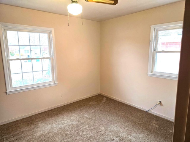 empty room featuring carpet floors and baseboards