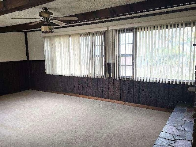 carpeted spare room with a ceiling fan