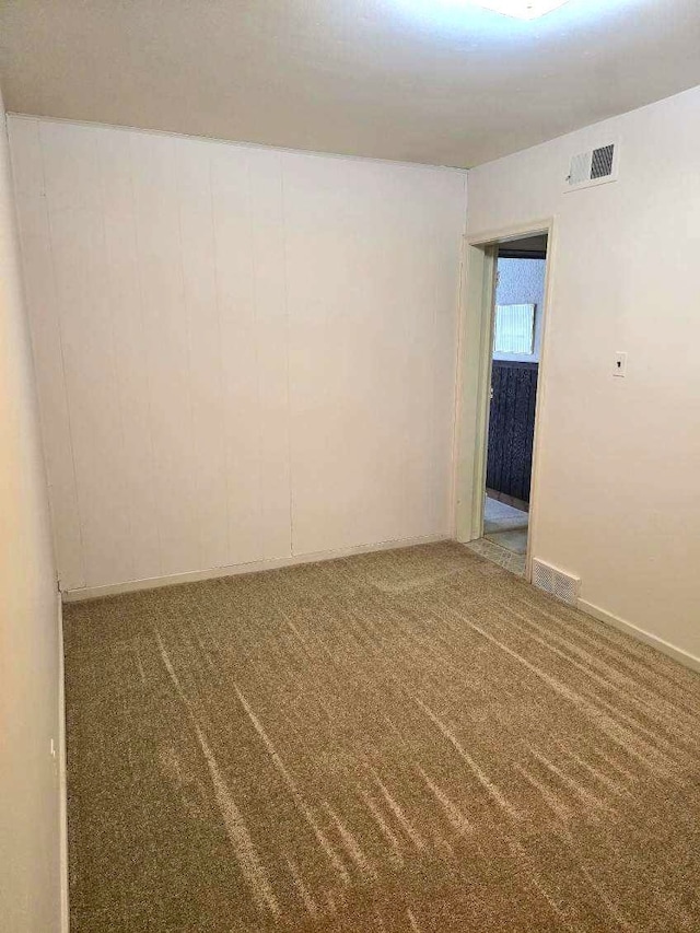 carpeted empty room with visible vents