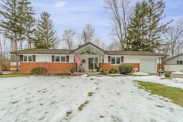 ranch-style house with a garage, brick siding, and a chimney