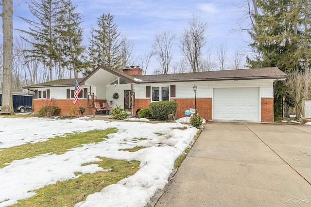 ranch-style home featuring a garage, concrete driveway, brick siding, and a chimney