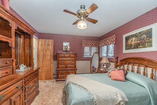 bedroom featuring light colored carpet and wallpapered walls