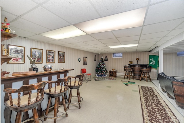 bar featuring a drop ceiling and tile patterned floors