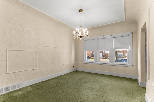 carpeted empty room with baseboards, visible vents, arched walkways, a textured wall, and a chandelier