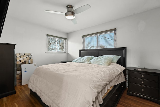 bedroom with dark wood-type flooring and a ceiling fan