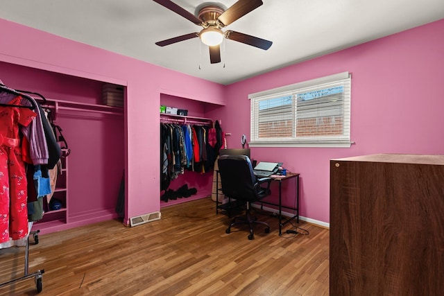 office featuring ceiling fan, wood finished floors, and baseboards