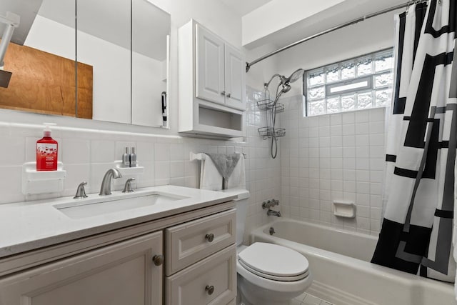 bathroom featuring tasteful backsplash, toilet, shower / bath combination with curtain, vanity, and tile walls