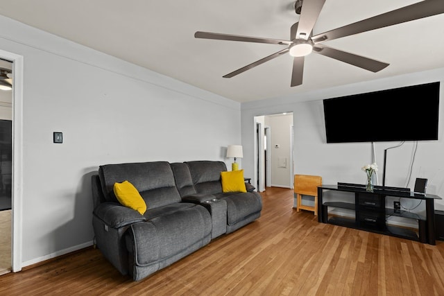 living room with baseboards, ceiling fan, and hardwood / wood-style floors