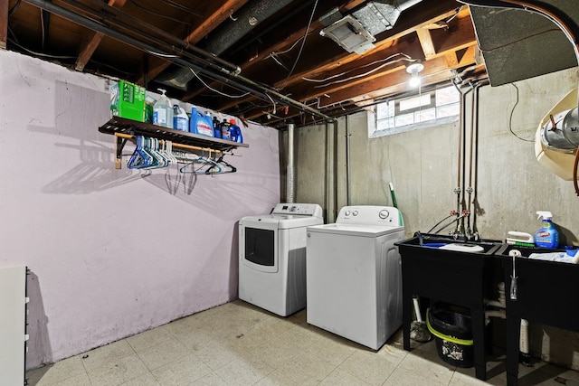 clothes washing area featuring laundry area, washing machine and clothes dryer, and tile patterned floors