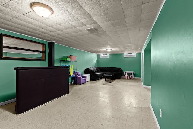 below grade area featuring baseboards and tile patterned floors