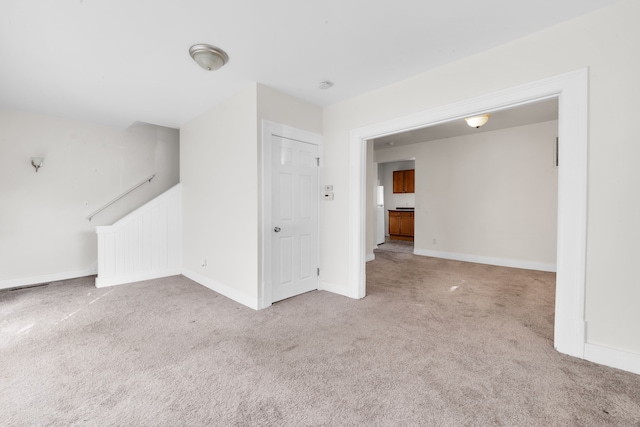 interior space with carpet, stairway, and baseboards