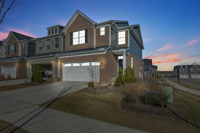 view of front facade with concrete driveway, a garage, and brick siding