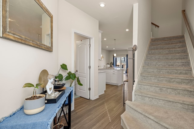 interior space with stairs, recessed lighting, and wood finished floors