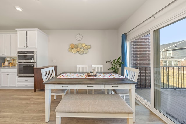 dining room featuring visible vents and light wood-style flooring