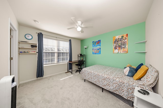 carpeted bedroom with heating unit, baseboards, and ceiling fan