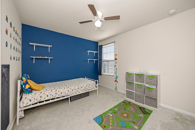 carpeted bedroom with baseboards and a ceiling fan