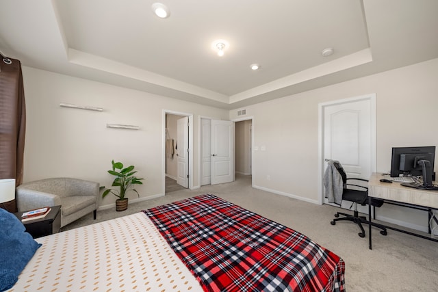 bedroom featuring a raised ceiling, carpet, and baseboards