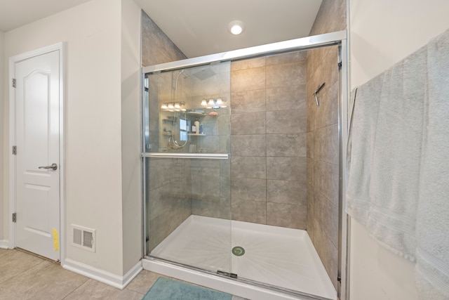 full bath with tile patterned floors, visible vents, baseboards, and a stall shower