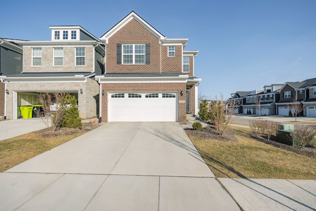 view of front of house with brick siding, stone siding, driveway, and a garage