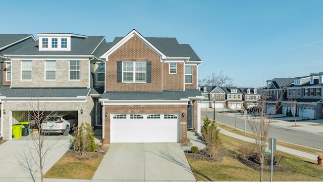 multi unit property featuring driveway, a residential view, a shingled roof, a garage, and brick siding