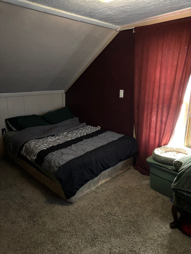 carpeted bedroom featuring lofted ceiling