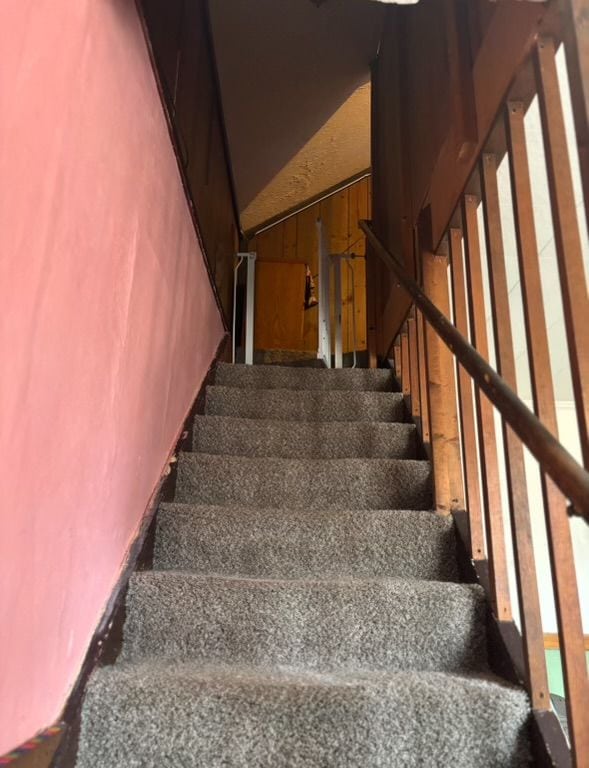 stairway featuring lofted ceiling