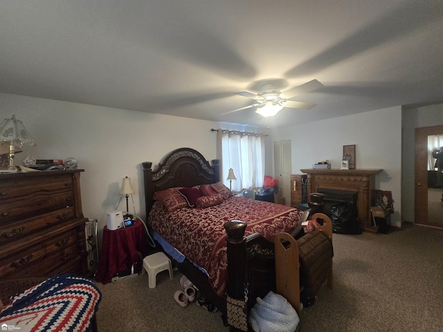 carpeted bedroom with a fireplace and ceiling fan