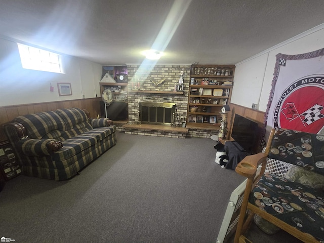 carpeted living room featuring a wainscoted wall, wooden walls, and a fireplace