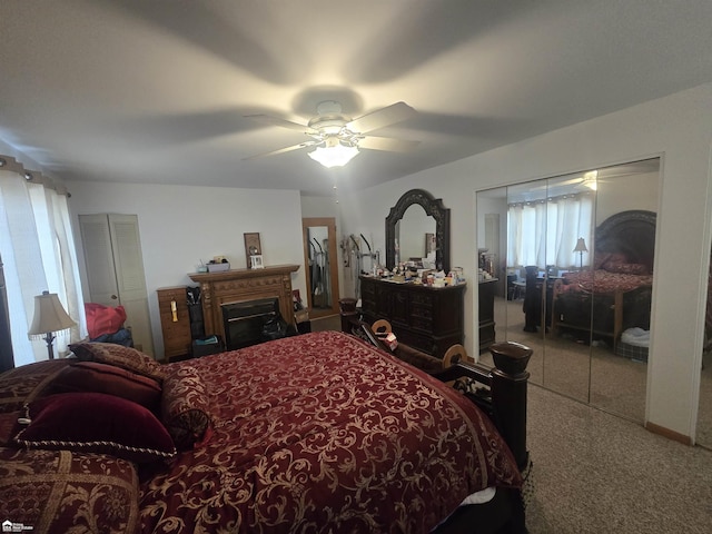 bedroom featuring a fireplace, a ceiling fan, and speckled floor