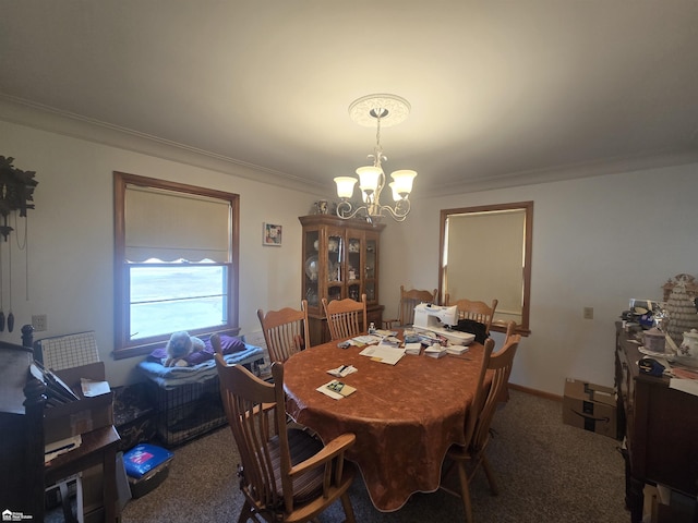 dining area featuring crown molding, carpet, baseboards, and an inviting chandelier