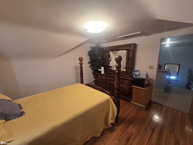 bedroom featuring attic access and wood finished floors