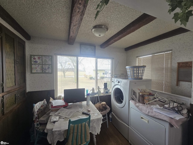 clothes washing area featuring dark wood finished floors, washing machine and dryer, a textured ceiling, laundry area, and wallpapered walls