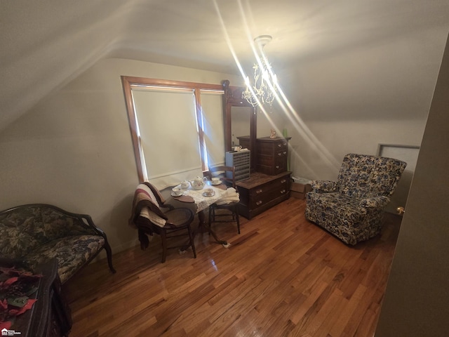 sitting room with vaulted ceiling and wood finished floors