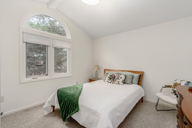 carpeted bedroom featuring vaulted ceiling with beams and baseboards