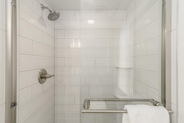 bathroom with a tile shower