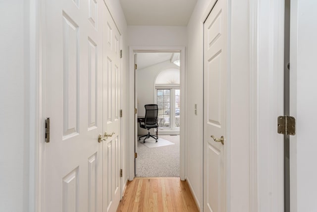 hallway featuring light carpet and light wood finished floors