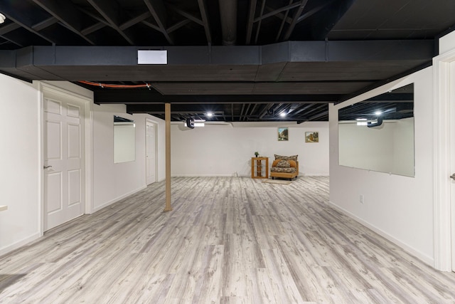 finished basement with wood finished floors and baseboards