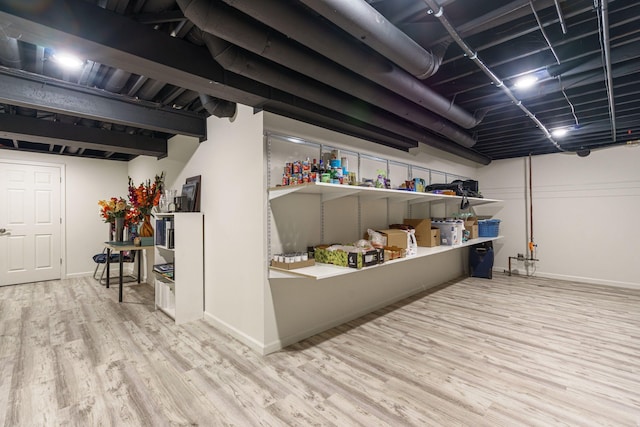 finished basement with baseboards and wood finished floors