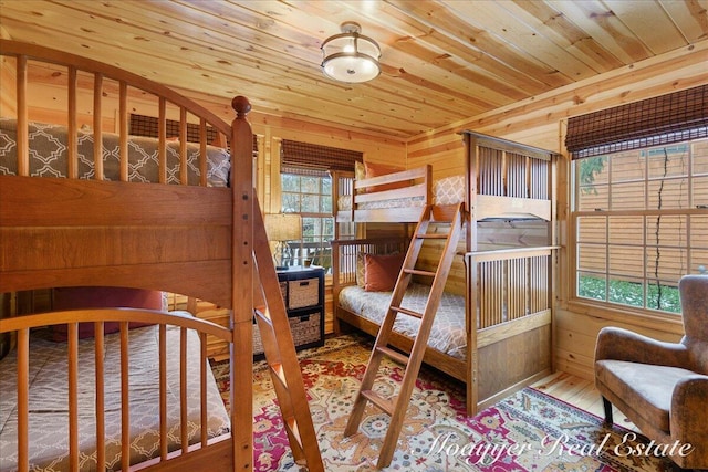 bedroom with wooden ceiling, wood walls, and wood finished floors