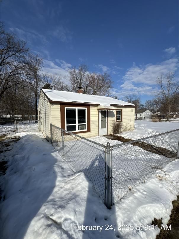 view of front of property featuring a fenced front yard and a chimney