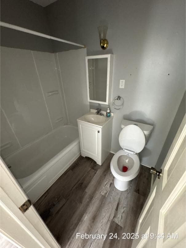 full bathroom with toilet, shower / bathing tub combination, wood finished floors, and vanity