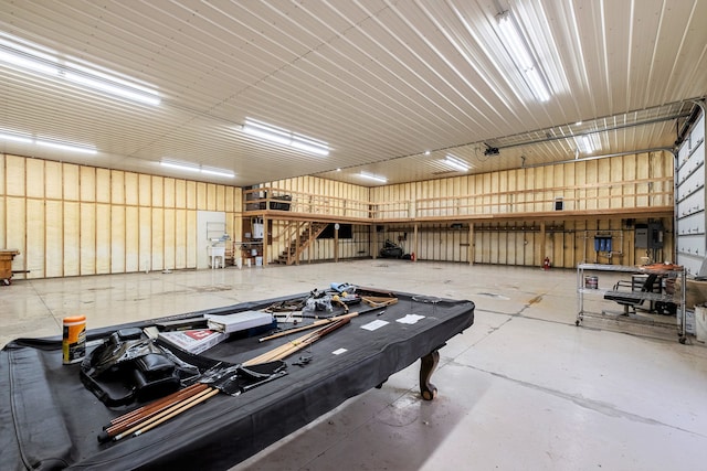 interior space with a garage, concrete floors, and metal wall