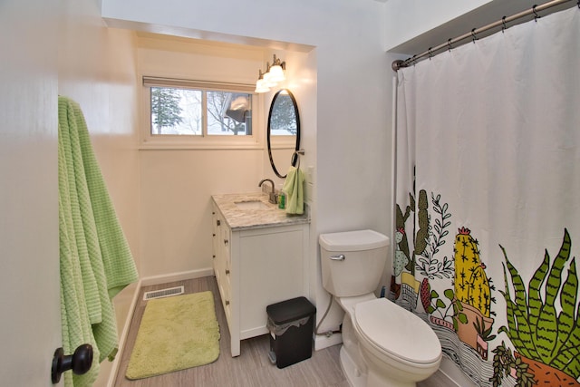 full bathroom featuring curtained shower, visible vents, toilet, vanity, and wood finished floors